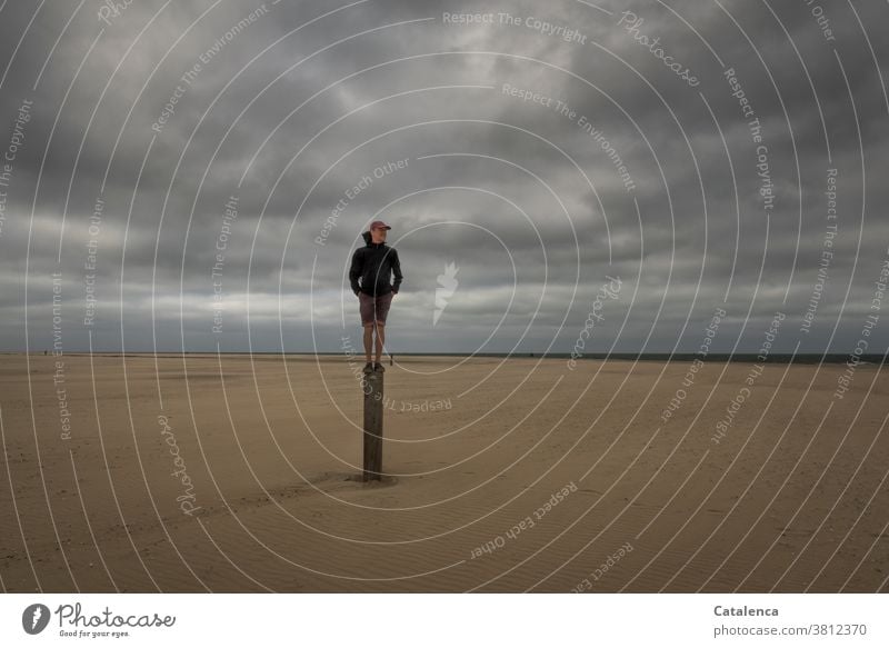 Promising, man standing on a pole on the beach on a cloudy day Beach Ocean coast North Sea Sky Horizon persons Sandy beach horizon Clouds Bad weather