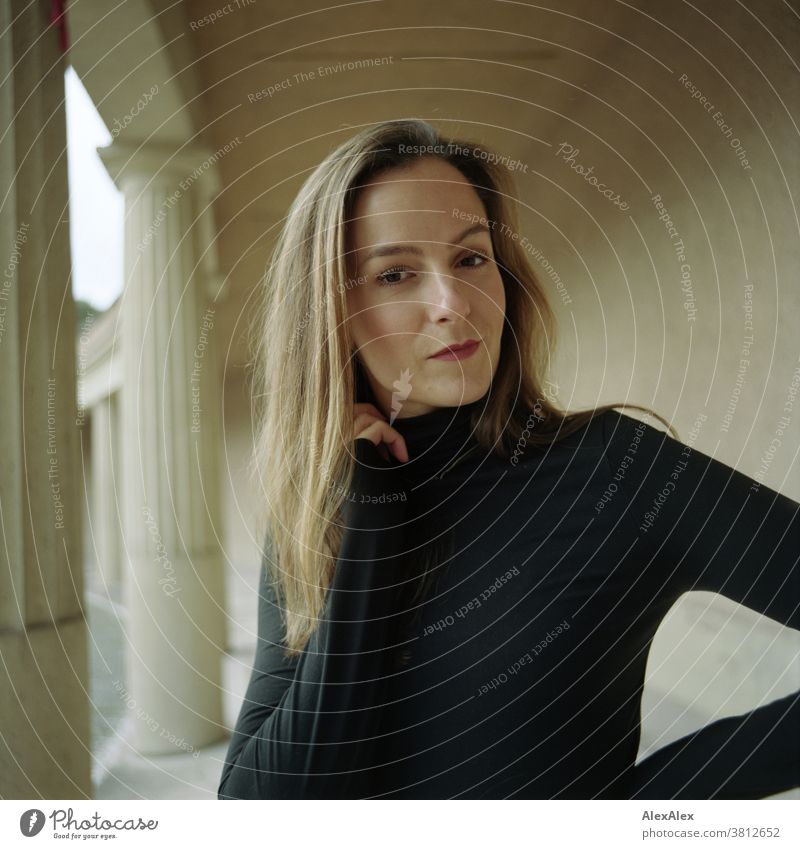 Close portrait of a young woman in a colonnade Woman 18 - 30 years pretty fit Slim smart kind Pleasant Attractive Brunette Long-haired salubriously Fresh teen