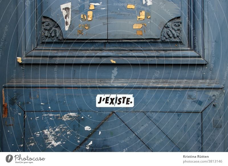 j'existe sticker on old wooden door I exist stickers Wooden door Plastered Patina street art urban Existence existentialism Philosophy philosophical French