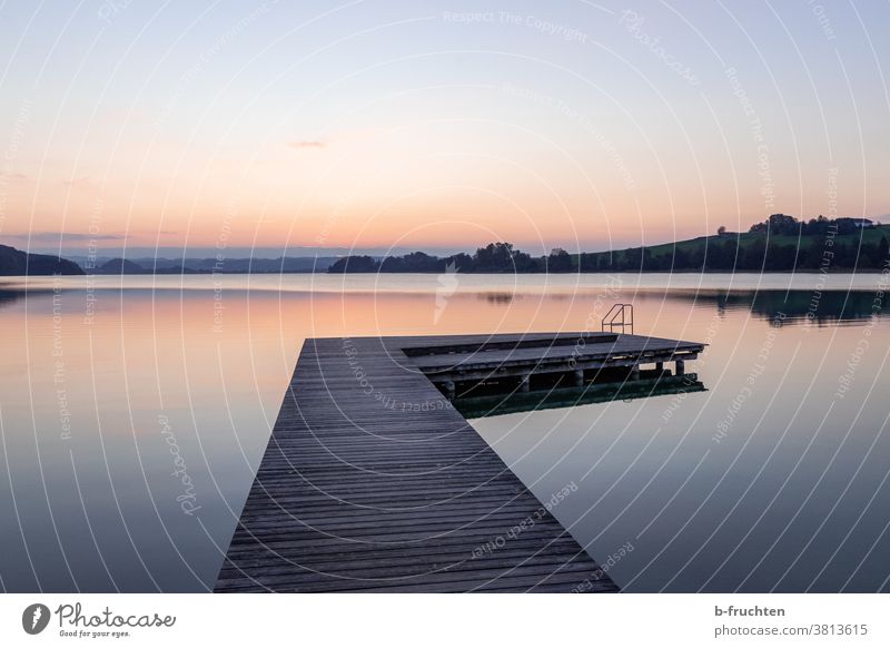 Calm lake with wooden jetty Footbridge Lake mattsee Austria silent Landscape Nature Reflection Lakeside Exterior shot Water Deserted Idyll Dusk evening mood