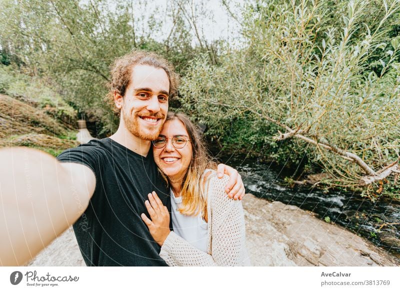 Young male pointing out something to his female partner in the middle of the forest smart phone vacation man outdoors picture people couple hike photo