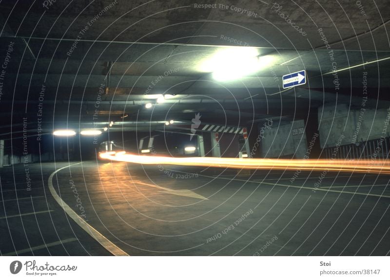 Parking garage at night Underground garage Night Strip of light Concrete Dark Gloomy Threat Architecture Town