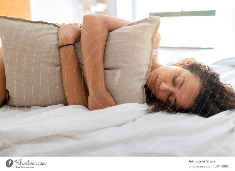 Happy young woman resting on bed bedroom happy awake morning lying optimist at home female relax cozy comfort smile cheerful joy delight eyes closed pleasure