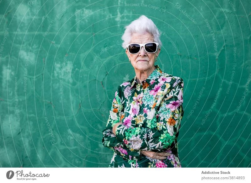 Stylish elderly woman in trendy sunglasses senior style hipster cool colorful outfit female fashion urban lifestyle bright individuality crazy happy cheerful