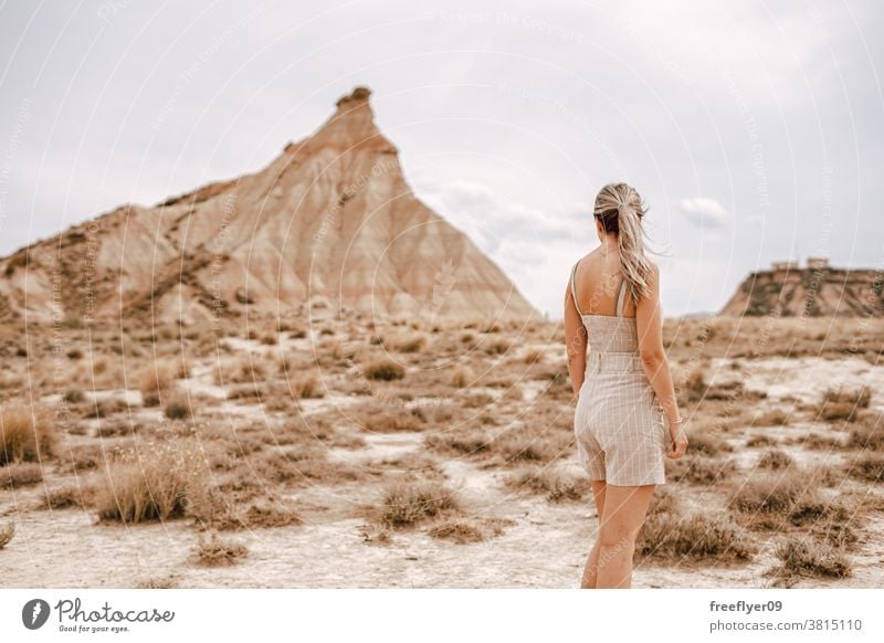 Young woman on the desert tourist blonde young 20s tourism travel copy space one mountain barcenas reales navarra iconic landmark spain nature tour tourism