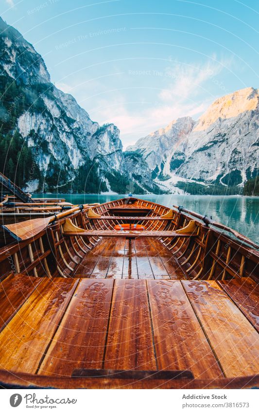 Wooden boat on clear lake in mountains turquoise water crystal vessel highland majestic wooden tranquil float calm scenic landscape nature idyllic peaceful pond