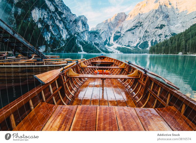 Wooden boat on clear lake in mountains turquoise water crystal vessel highland majestic wooden tranquil float calm scenic landscape nature idyllic peaceful pond