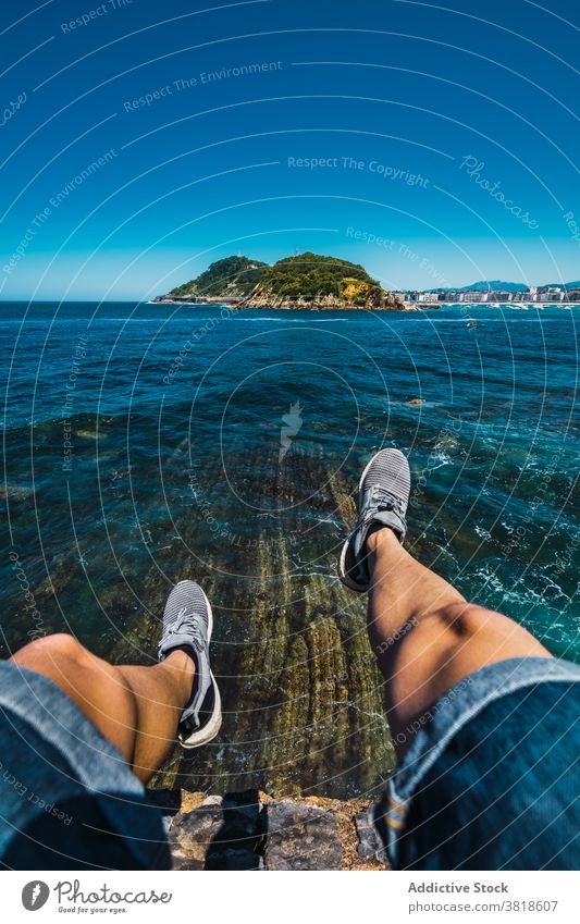 Anonymous traveler contemplating sea from mountain under blue sky tourist contemplate nature seascape trip wanderlust summer admire highland ocean pure wavy