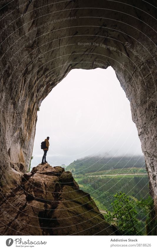 Unrecognizable tourist admiring mountains in fog during trip admire nature highland vegetate sky atmosphere wanderlust man rucksack rough bristly natural beauty