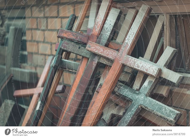 a lot of wooden Christian crosses on brick wall catholic catholicism christianity culture god cemetery jesus memorial monument religion religious tradition used