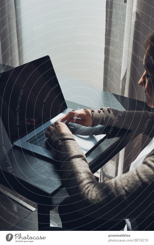 Businesswoman working remotely on her laptop managing her work sitting in a cafe business caucasian computer connection desk entrepreneur female indoors