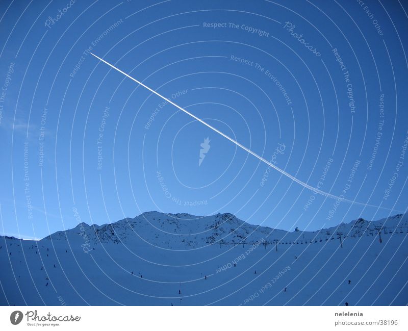 Condensation trails over the mountains Airplane Vapor trail Sölden Vacation & Travel Panorama (View) Glacier Mountain Snow Blue Sky Sports Flying Aviation Tall