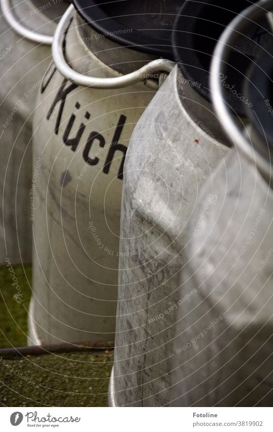 Very old milk churns made of sheet metal with handle and lid. On one pot is the word "kitchen". Milk churn Colour photo Deserted Jug Old Exterior shot Retro