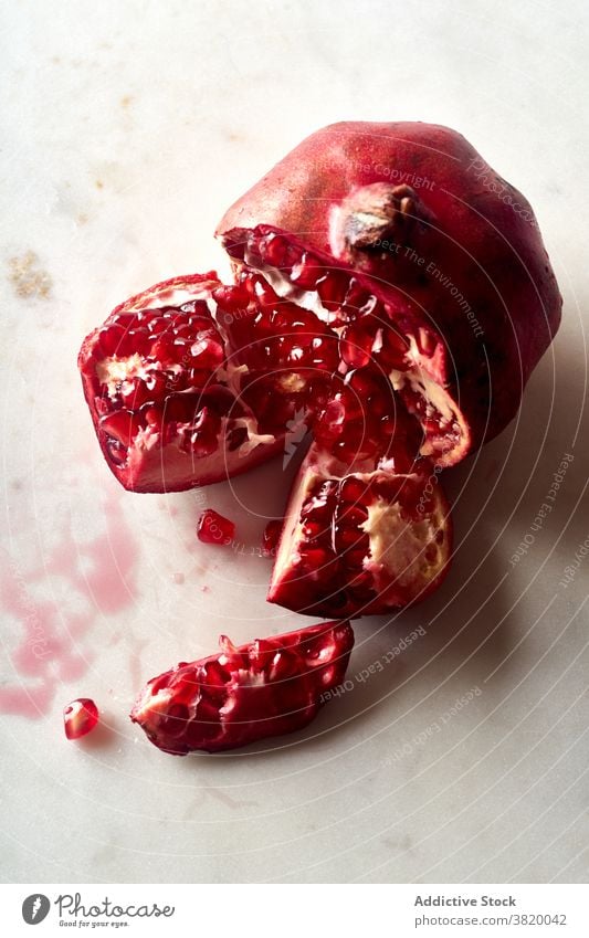 Fresh ripe halved pomegranate fruit healthy food red tropical juicy seed sweet vegetarian raw fresh natural half freshness closeup eating vitamin ingredient