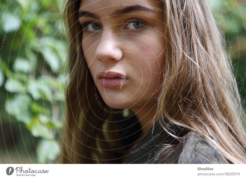 Lateral portrait of a girl in front of a deciduous tree Landscape Beach Intensive teen kind Nature feminine Uniqueness Exceptional natural light