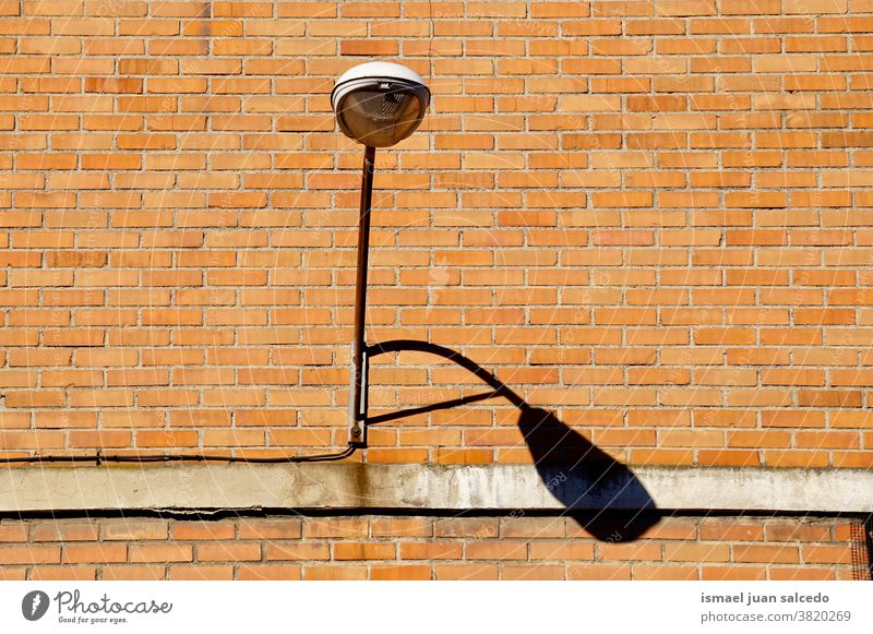 street lamp on the building wall street light streetlight lampposts lamps illumination lighting equipment city metallic object outdoors background old urban