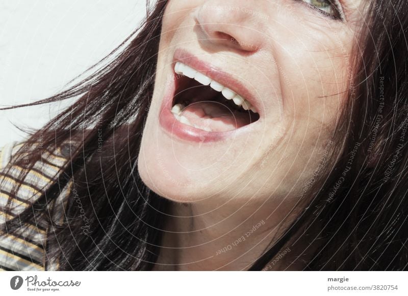 The face of a woman with laughing mouth Woman Young woman Feminine Human being Exterior shot Adults Dark-haired Cheek contented To enjoy Light Head Day