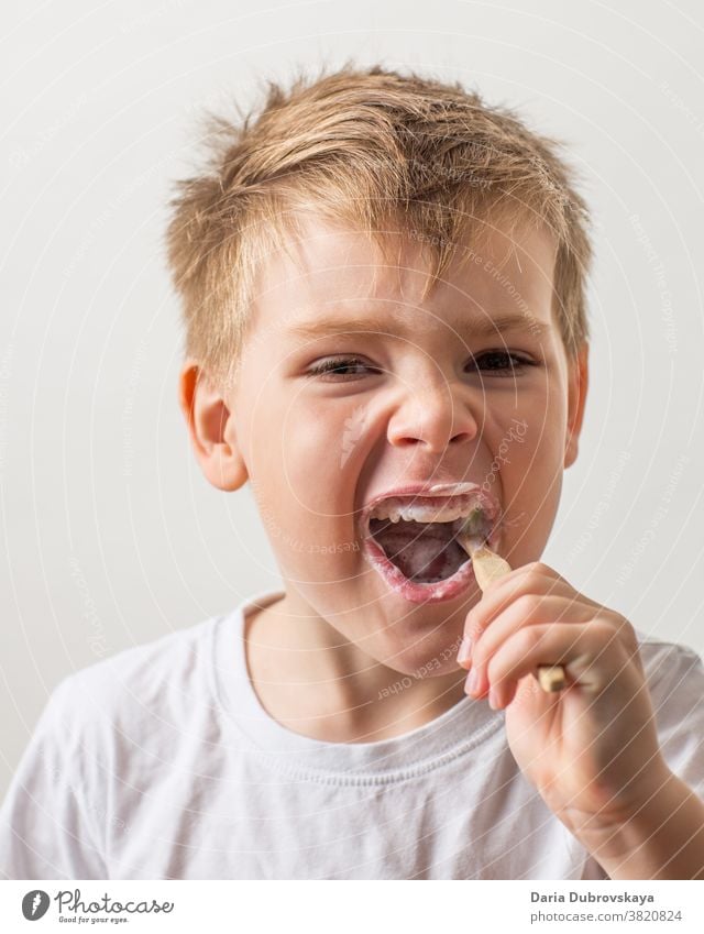 Boy brushing teeth with bamboo toothbrush oral healthy toothpaste mouth lifestyle portrait childhood expression healthcare cute boy protection kid young dental