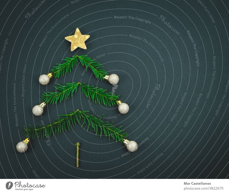 Christmas tree made with pine branches on a black background. decoration christmas end of the year star balls space copy christmas tree decorations concept