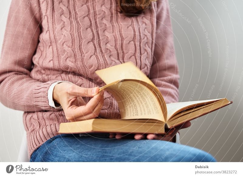 Woman sitting and reading a book. Relaxing concept page relax education turn open row document knowledge science stack old person people adult lifestyle