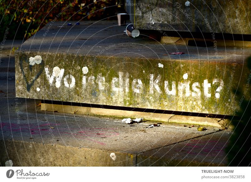 When the muse kisses you, you don't have to ask yourself, "Where is the art?" Grafitti on the Platz der Einheit in Potsdam in white on concrete steps, illuminated by the evening sun, garnished with some garbage