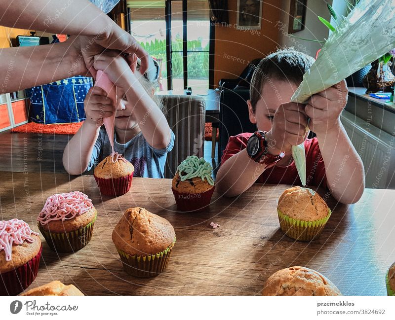 Children baking cupcakes, preparing ingredients, decorating cookies children cooking bake family domestic muffin together childhood happy little kid kitchen