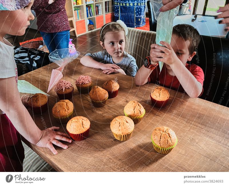 Children baking cupcakes, preparing ingredients, decorating cookies children cooking bake family domestic muffin together childhood happy little kid kitchen