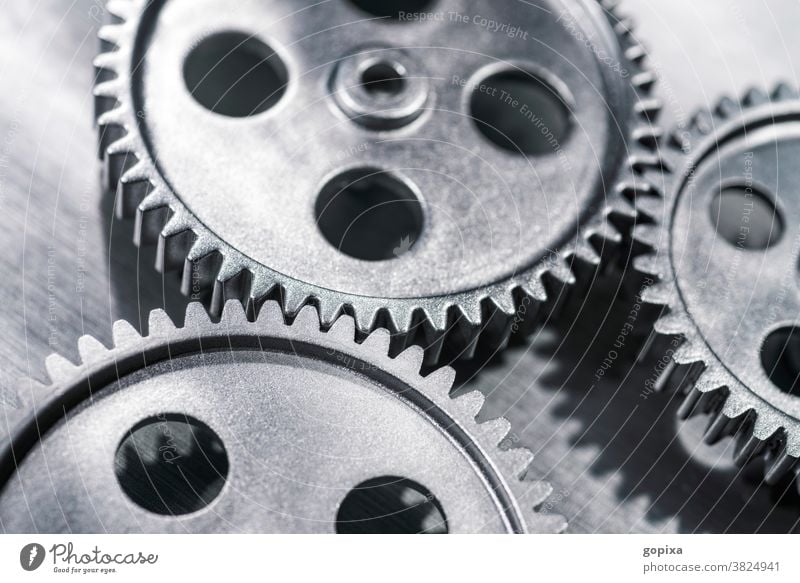 Three gear wheels mesh with each other Gearwheel Industry Impulsion Teamwork Network Metal Gear unit Engines Economy Business Infrastructure Mechanics