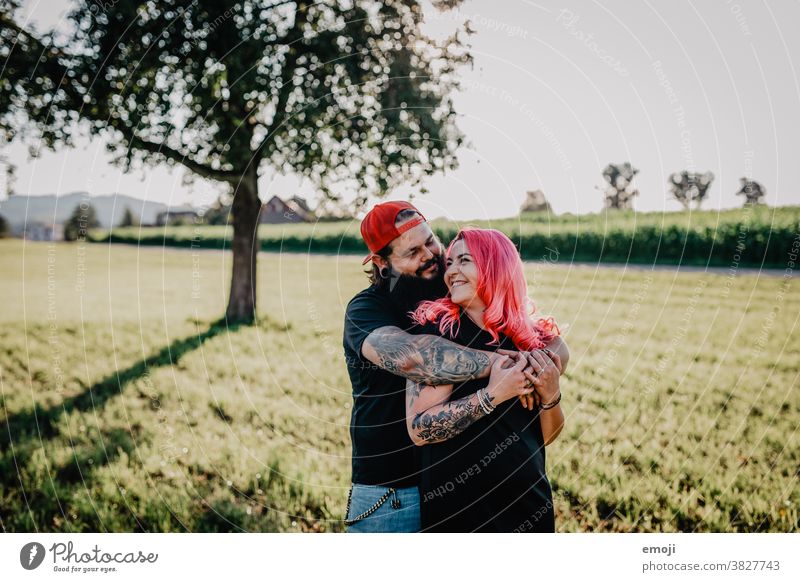 young couple with tattoos and pink hair teen Couple Love In love hug out Field Tattoo heartfelt Cuddling Hip & trendy Hipster Man Woman cheerful fortunate Happy