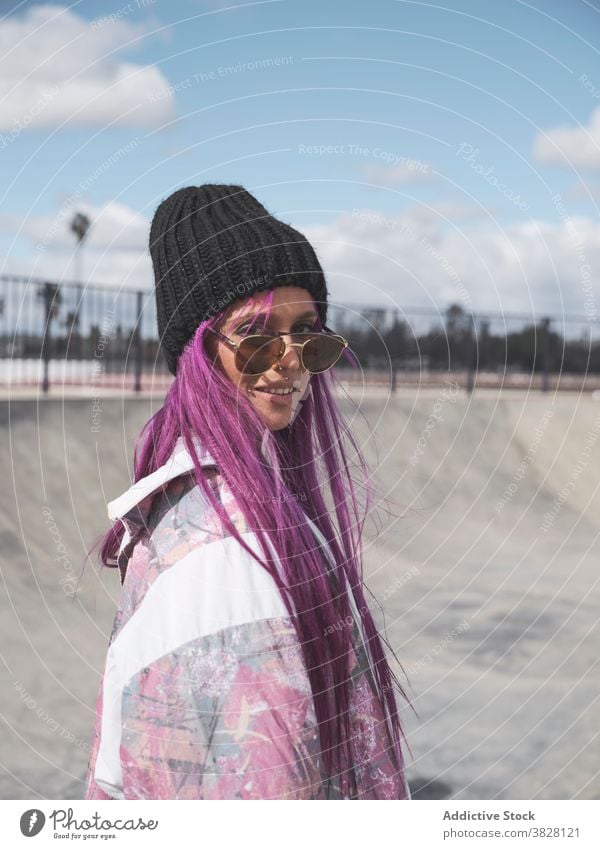 Stylish woman with pink hair in roller skates skate park hipster street style informal eccentric appearance female hobby having fun outfit trendy urban city