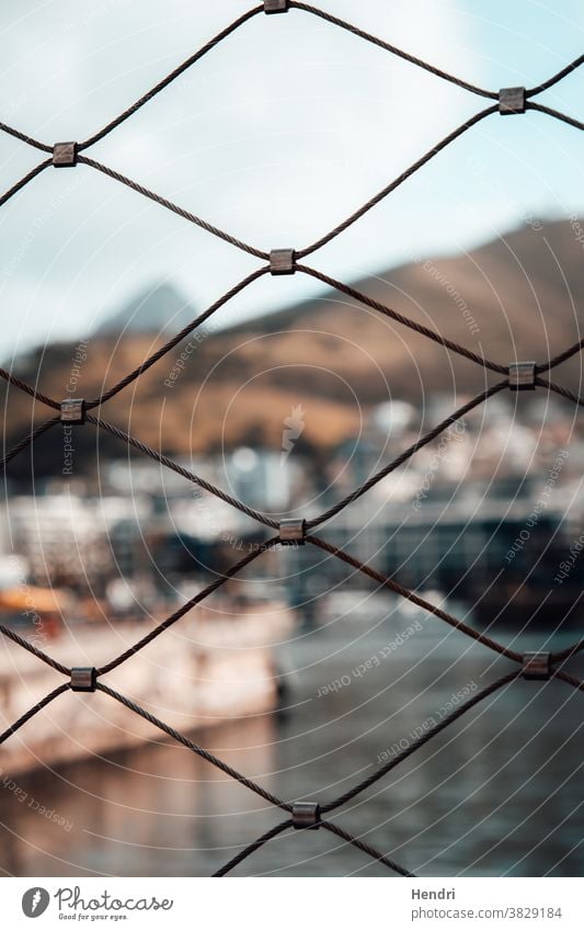 Fence with Beautiful view of a Canal and Mountains fence beautiful canal mountains Exterior shot Day Landscape Summer fencing canals italy boat boats protect