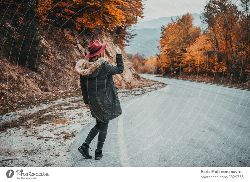 Woman with hat exploring the autumn forest autumn colors autumn leaves autumn vibes background beautiful beautiful woman caucasian celebration clean clothes