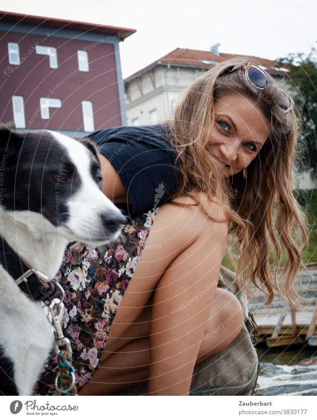 Beautiful woman kneels beside her dog and smiles Woman pretty cheerful Smiling rays Dog portrait Feminine Adults Brunette hair Kneel