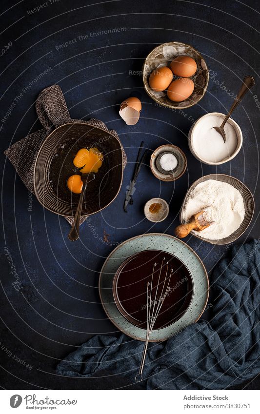 Bowls with ingredients during brownie cake preparation prepare set process recipe cook various utensil bowl food chocolate egg flour cacao sugar vanilla cuisine