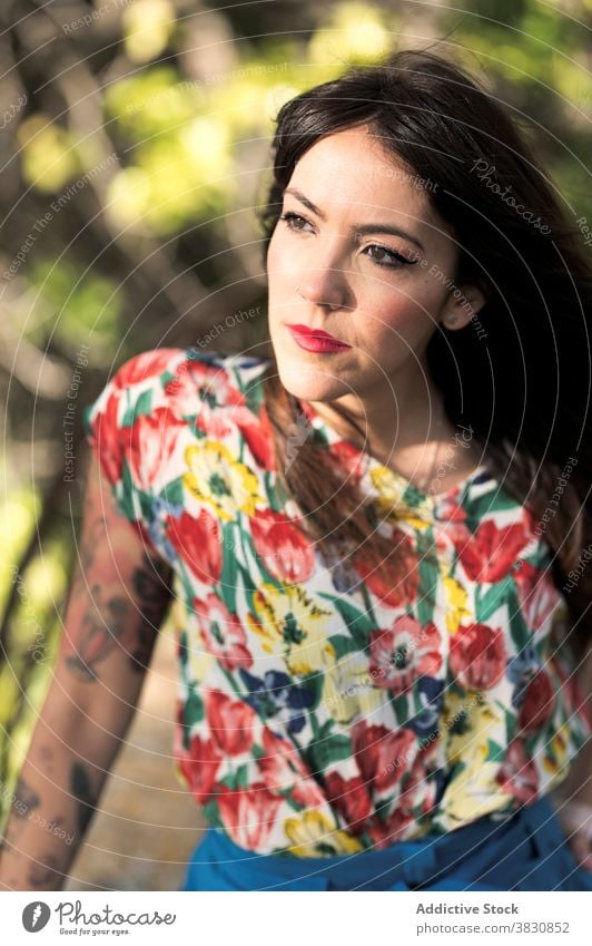 Dreamy woman raising leg while standing near fence dreamy leg raised thoughtful park forest summer greenery slender railing female beautiful gorgeous attractive