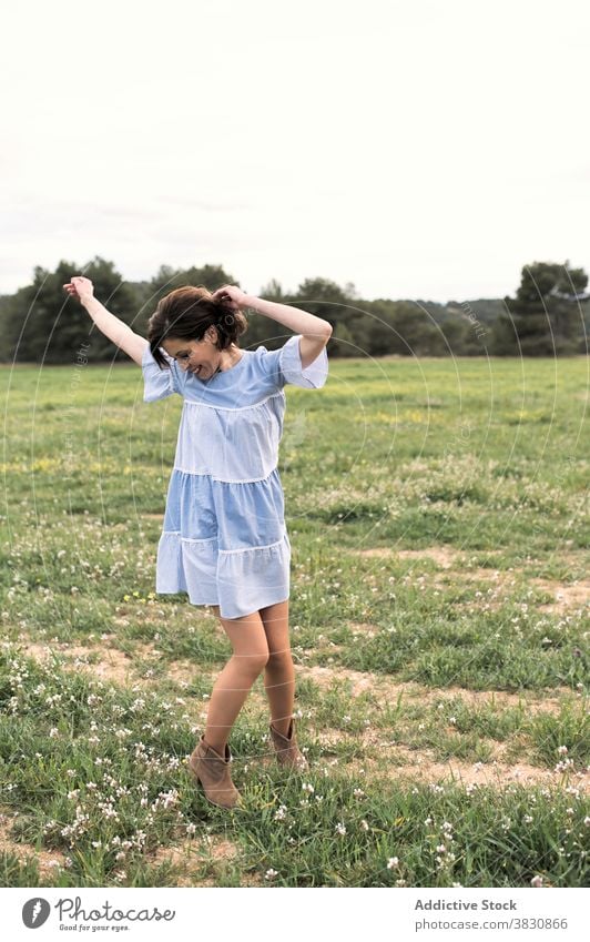 Happy woman walking in field in summertime stroll meadow allure romantic freedom female arms apart grass cute forest nature daytime cheerful valley slope hill