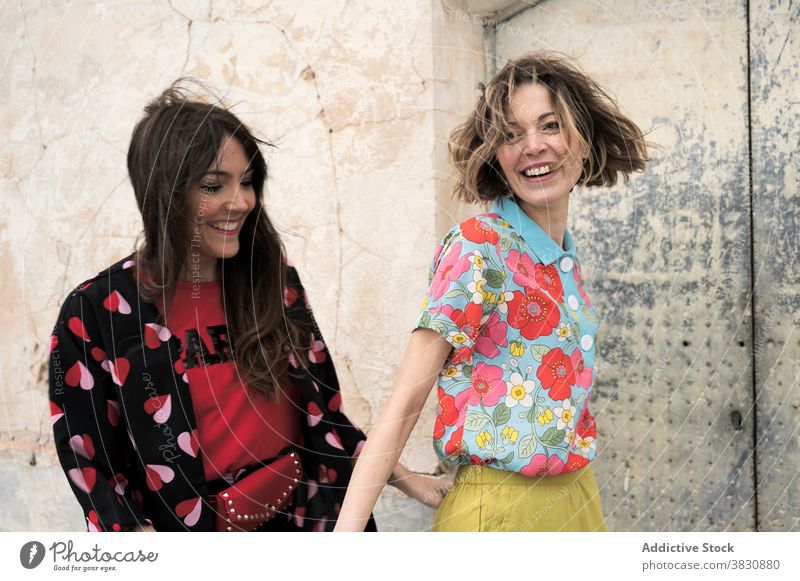 Happy woman near weathered wall women friendship cheerful exterior toothy smile happy skinny summer laugh shabby crack lifestyle enjoy positive content delight