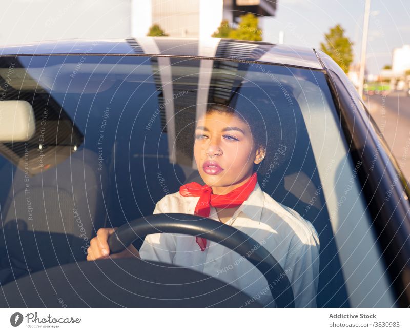 Serious black woman driving car driver serious confident busy work female transport thoughtful automobile lady african american communicate road device gadget