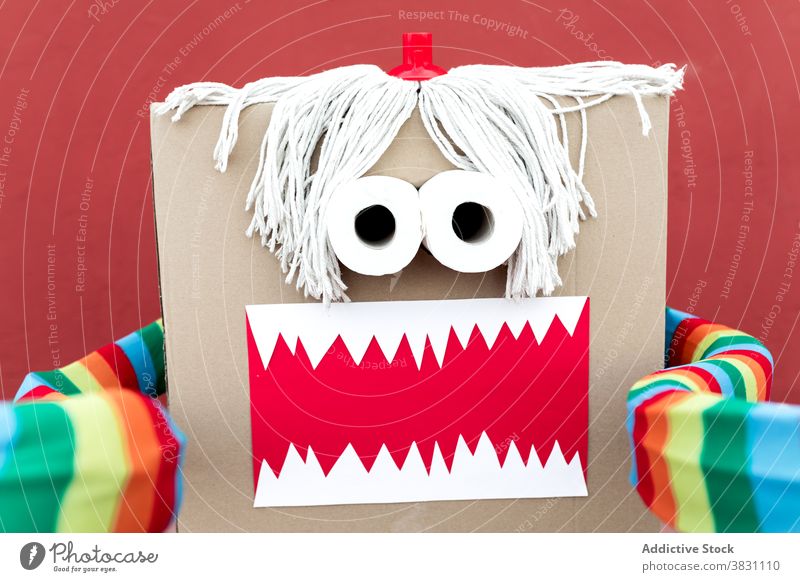 Child in funny carnival costume on street monster carton box child playful vivid handmade creative holiday party festive celebrate kid event fantasy masquerade