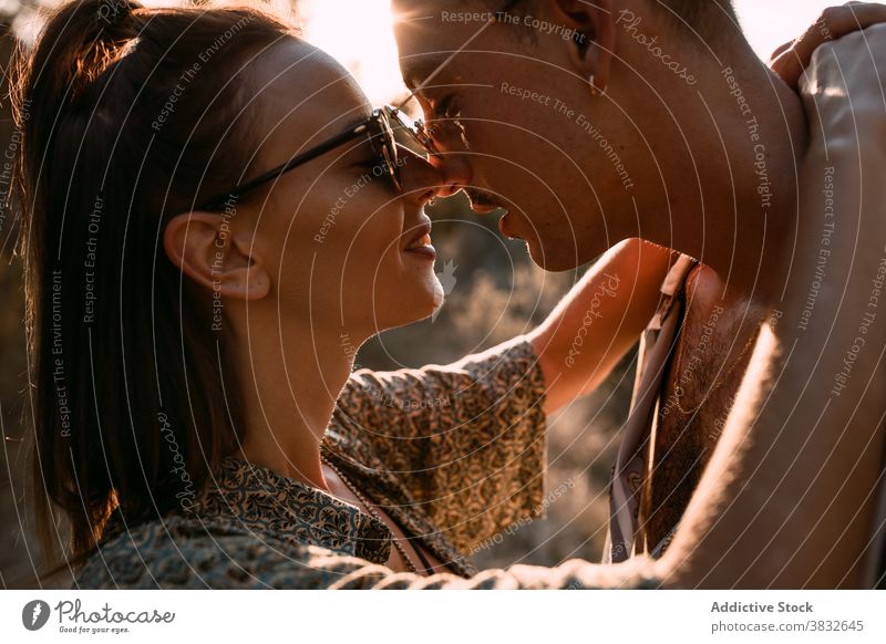 Loving couple hugging in nature at sunset love gentle evening style together relationship sundown sky romantic boyfriend affection casual embrace relax tender