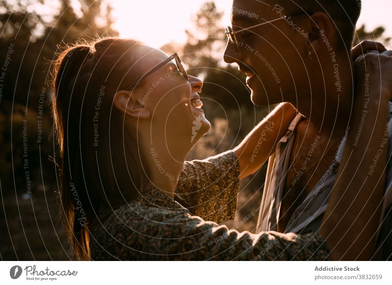 Loving couple hugging in nature at sunset love gentle evening style together relationship sundown sky romantic boyfriend affection casual embrace relax tender