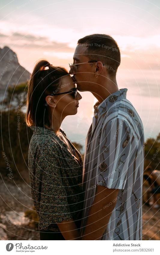 Couple in love kissing at sunset couple sea passion amorous cuddle hill relationship embrace romantic affection together hug boyfriend sky evening bonding