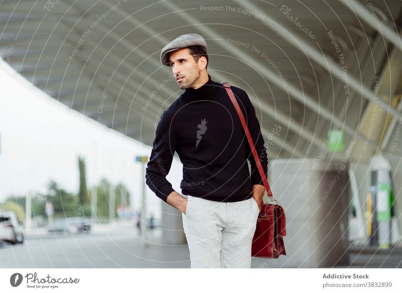 Positive man walking near the airport smile positive cheerful road street style using male beard ethnic trendy asphalt parked daytime city gadget urban vehicle