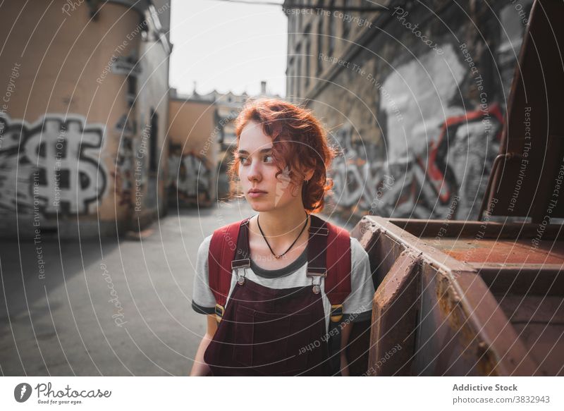 Hipster woman standing near old building with graffiti in city urban hipster millennial shabby aged street district saint petersburg russia russian federation