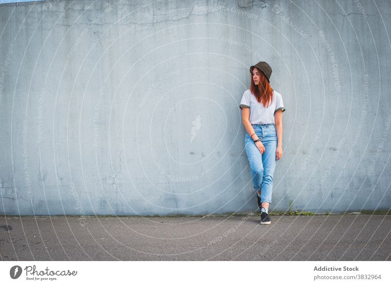 Hipster young woman in hat standing near wall hipster trendy millennial urban style student casual teen red hair redhead female outfit fashion lifestyle teenage