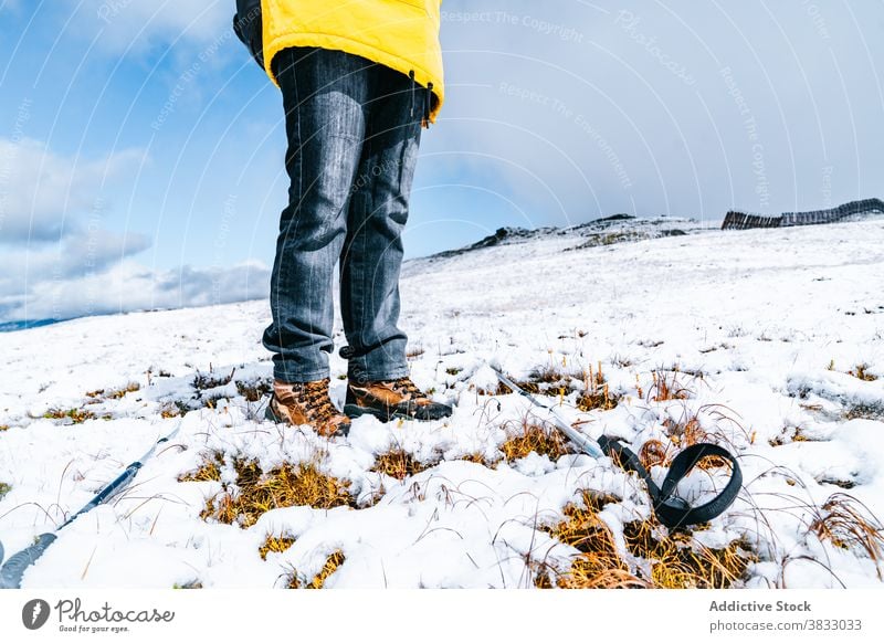 Crop traveler with trekking poles in mountains in winter hiker snow mountaineer slope sunny wintertime pyrenees mountains andorra nature cold vacation trip