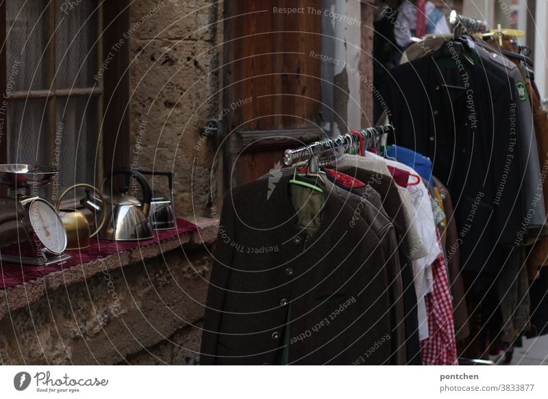 Flea market items in front of a thrift store. Antiques garments Second-hand Load business sale clothes rail Window Goods traditional jacket Scale can Trade