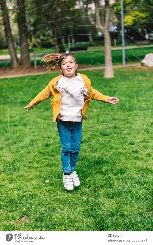 Beautiful little girl jumping over the rope in the park on sunny day outdoor 1 happy childhood happiness play cute fun outside summer beautiful person joy one