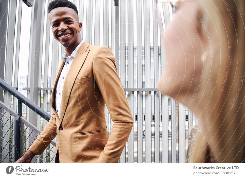 Young Businessman And Businesswoman Meeting Outside Office Building business businessman businesswoman airport office building commuter commuting meeting