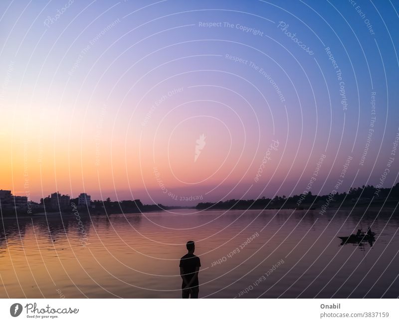 Man standing middle of the river Standing Middle River Sunset Colorful Landscape Still Life Expressive Nature Colour photo Vacation & Travel River bank Water